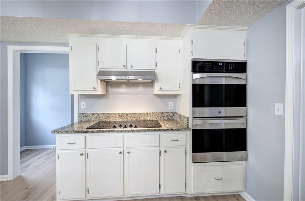 16 High Point Drive Southwest Cartersville, GA 30120 - Photo 17 of 44 a kitchen with stainless steel appliances granite countertop a stove and white cabinets