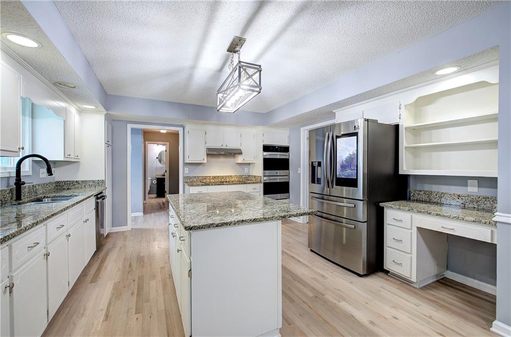 16 High Point Drive Southwest Cartersville, GA 30120 - Photo 18 of 44 a kitchen with stainless steel appliances granite countertop a sink stove and refrigerator