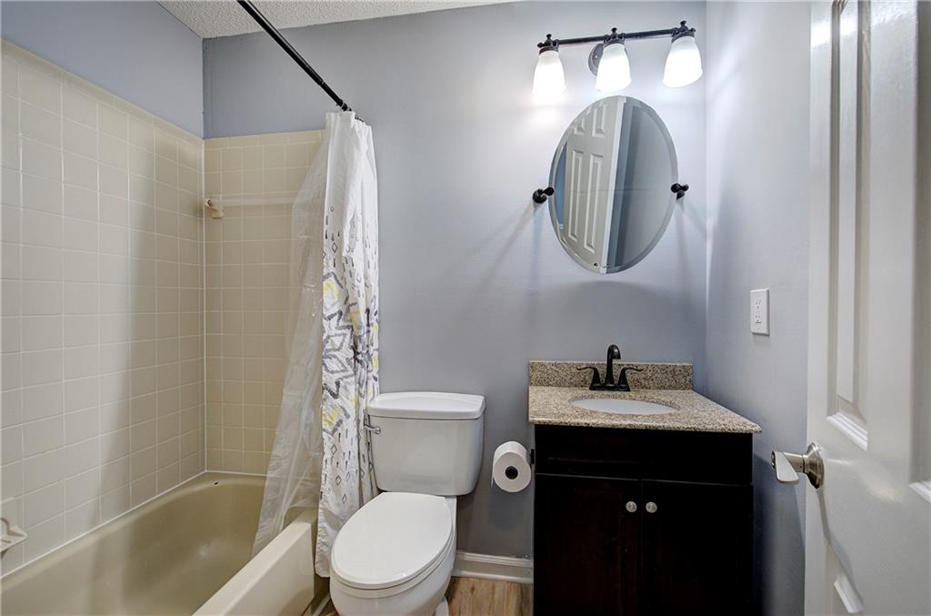 16 High Point Drive Southwest Cartersville, GA 30120 - Photo 22 of 44 a bathroom with a toilet sink vanity tub and shower