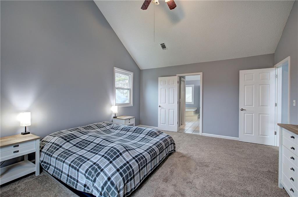 16 High Point Drive Southwest Cartersville, GA 30120 - Photo 26 of 44 a bedroom with a bed and a lamp