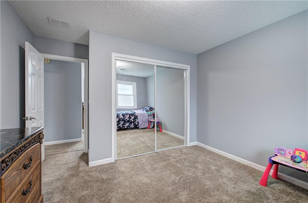 16 High Point Drive Southwest Cartersville, GA 30120 - Photo 34 of 44 a view of a livingroom with wooden floor and a flat screen tv