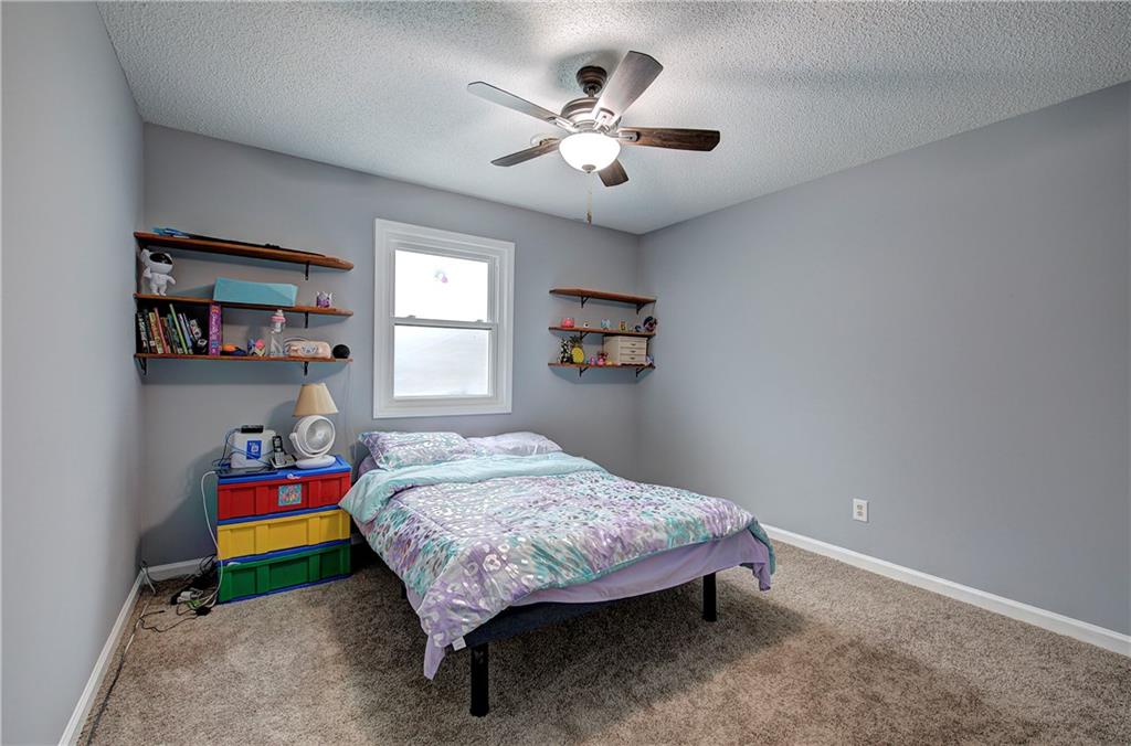 16 High Point Drive Southwest Cartersville, GA 30120 - Photo 35 of 44 a bedroom with a bed and a chandelier