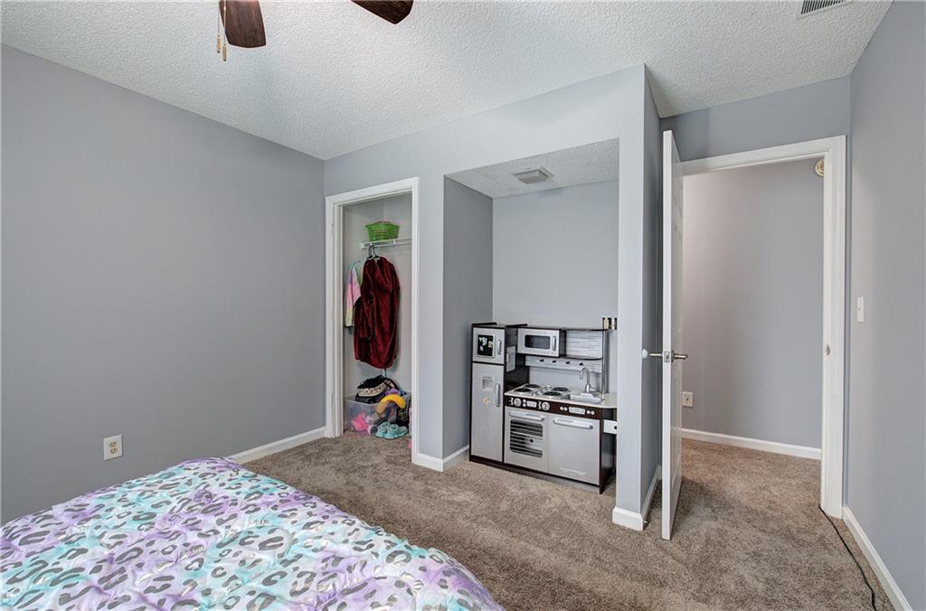 16 High Point Drive Southwest Cartersville, GA 30120 - Photo 36 of 44 a view of a bedroom with refrigerator and closet