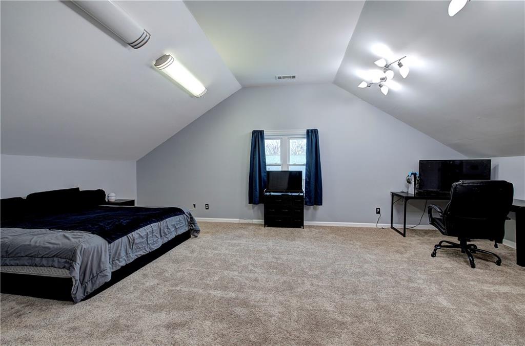 16 High Point Drive Southwest Cartersville, GA 30120 - Photo 39 of 44 a spacious bedroom with a bed and a chandelier