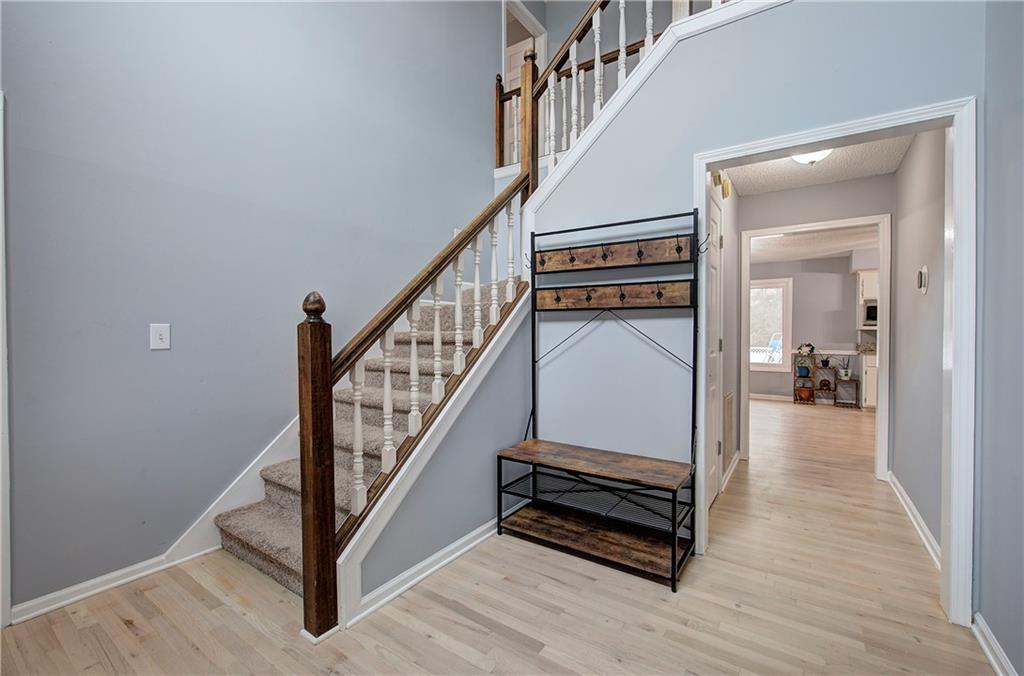 16 High Point Drive Southwest Cartersville, GA 30120 - Photo 5 of 44 a view of a hallway with wooden floor and staircase