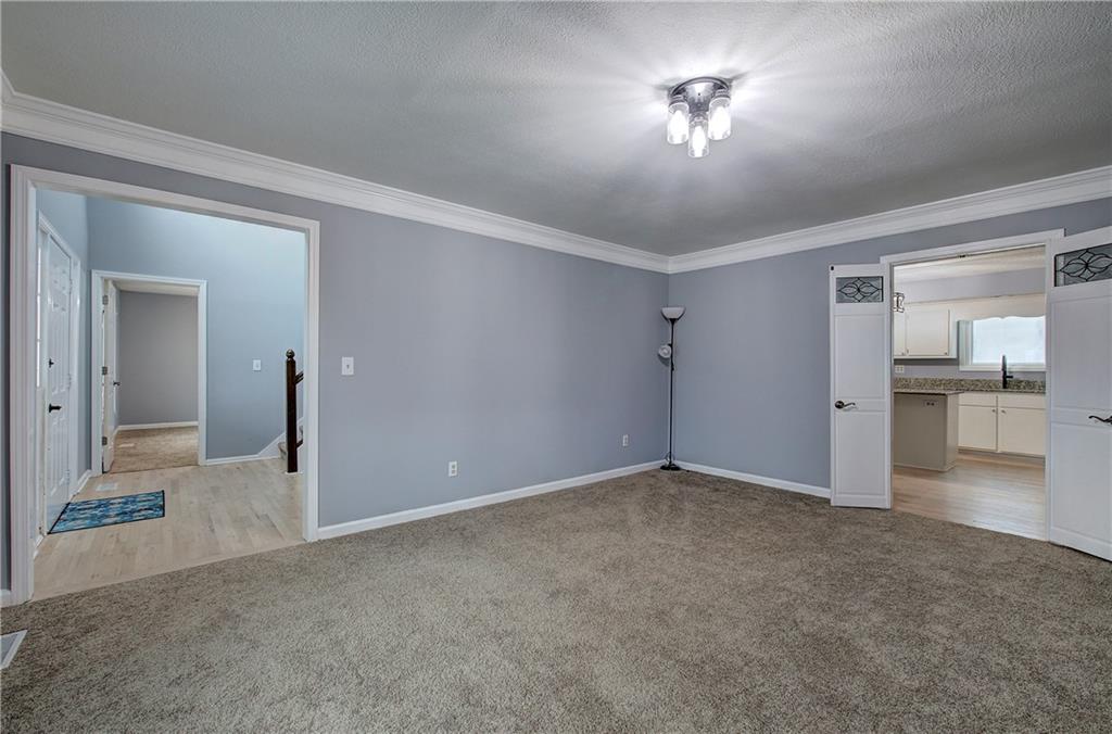 16 High Point Drive Southwest Cartersville, GA 30120 - Photo 6 of 44 a view of a big room with a chandelier fan and windows