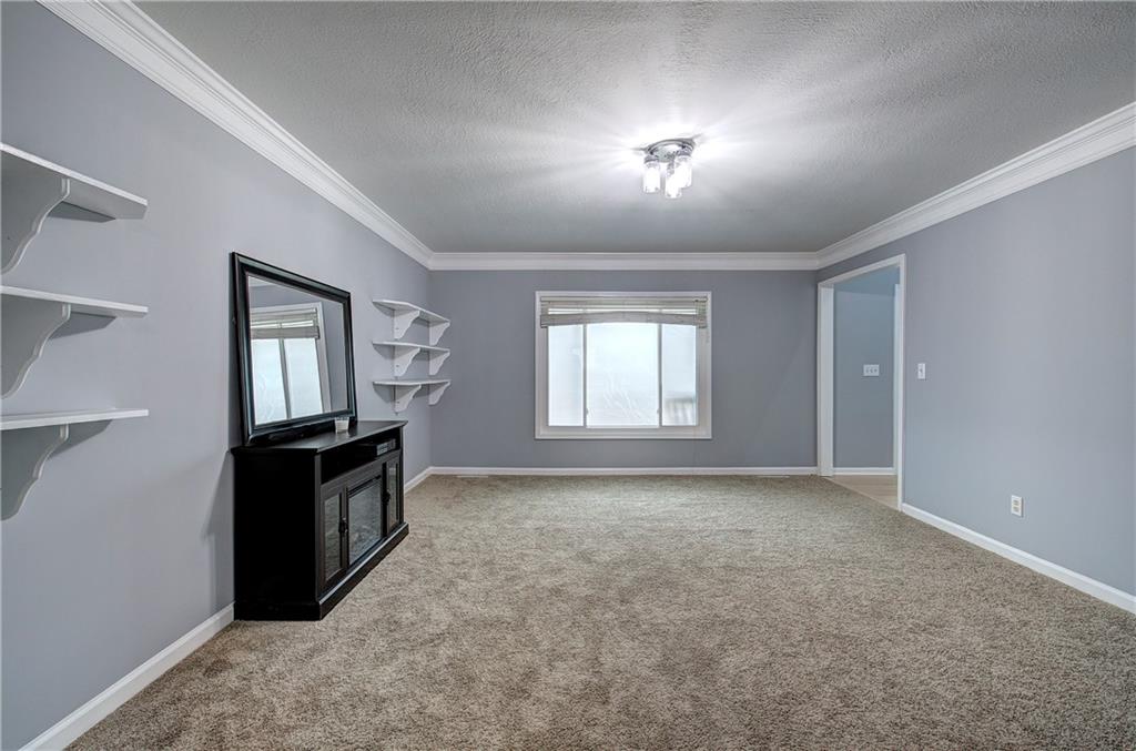 16 High Point Drive Southwest Cartersville, GA 30120 - Photo 7 of 44 a view of an empty room with window and wooden floor