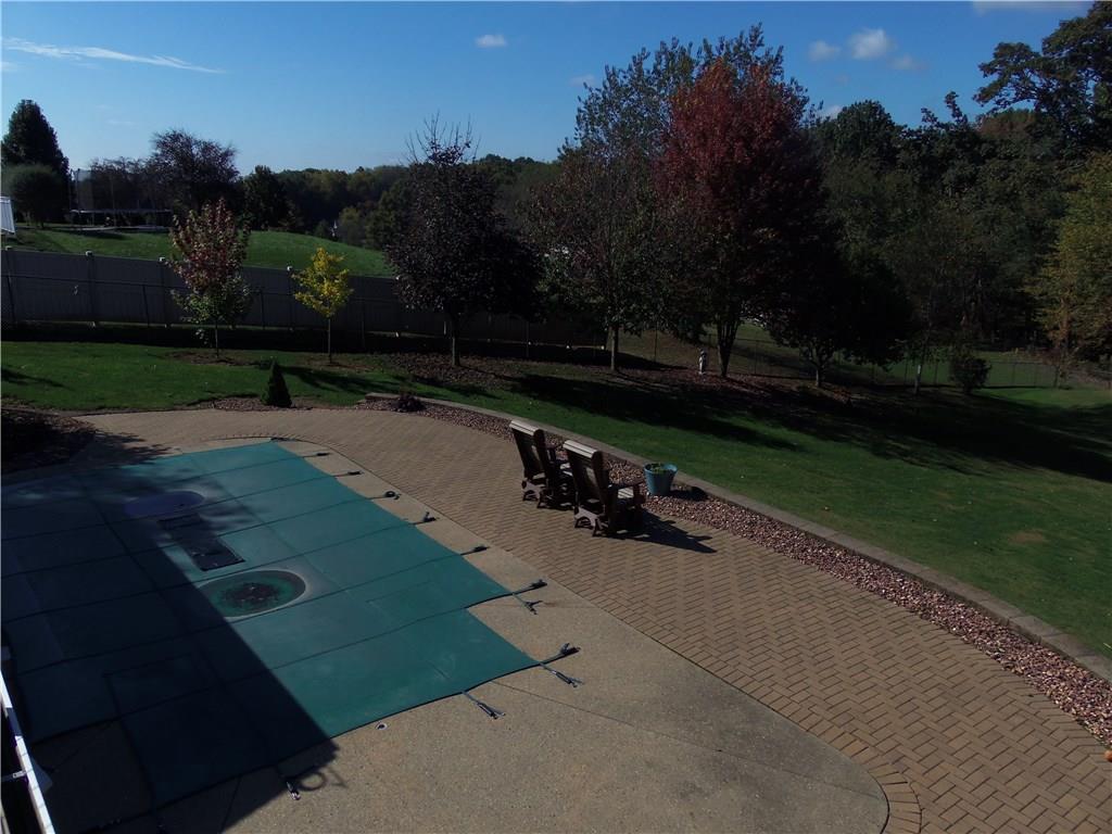 170 Heck Road Sarver, PA 16055 - Photo 22 of 25 Inground saltwater pool situated off the sunroom with surrounding Omni-stone patio area