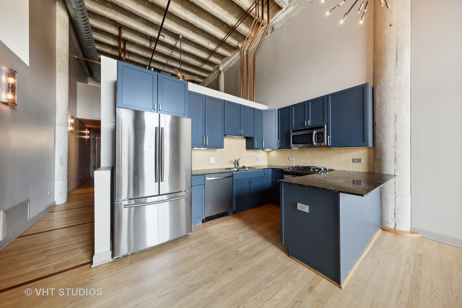 2545 South Dearborn Street, Unit 331 Chicago, IL 60616 - Photo 5 of 17 a kitchen with stainless steel appliances granite countertop a refrigerator a sink and a stove
