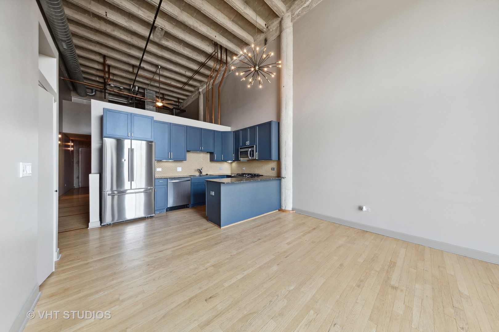 2545 South Dearborn Street, Unit 331 Chicago, IL 60616 - Photo 6 of 17 a kitchen with stainless steel appliances a refrigerator and a wooden cabinets