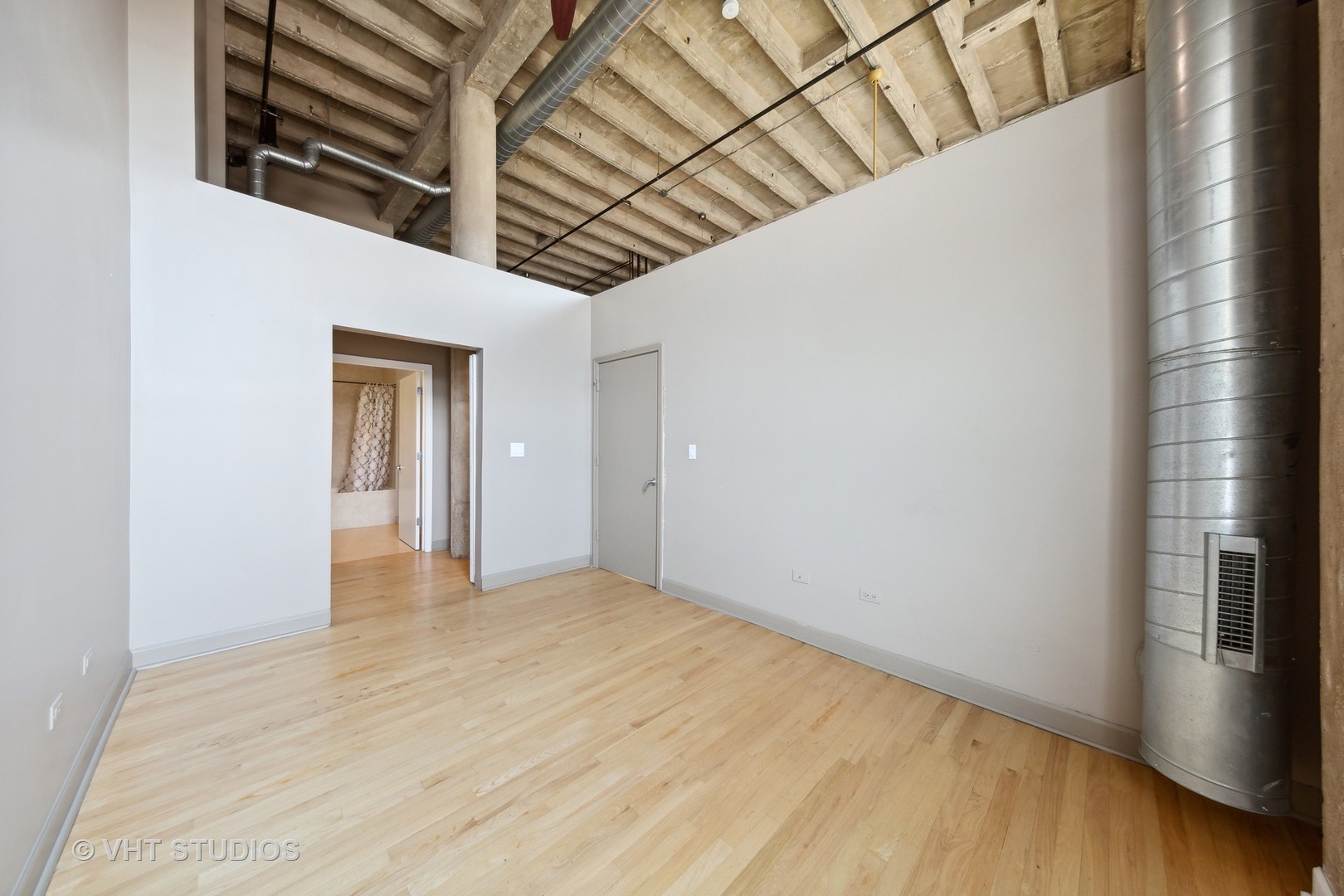 2545 South Dearborn Street, Unit 331 Chicago, IL 60616 - Photo 8 of 17 a view of an empty room with wooden floor