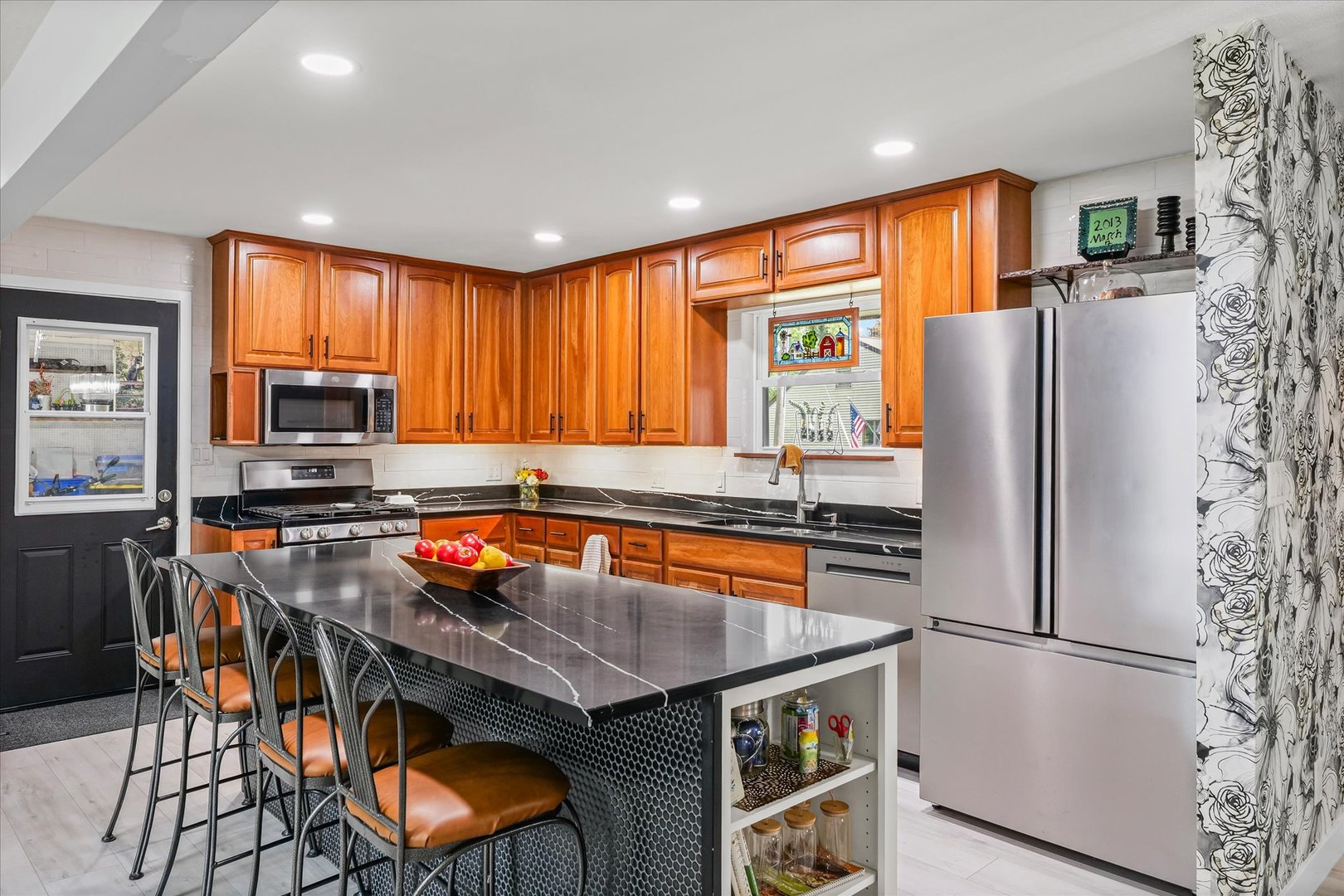 5 Golfview Drive Savoy, IL 61874 - Photo 11 of 42 a kitchen with stainless steel appliances granite countertop a refrigerator a stove a sink a dining table and chairs with wooden floor