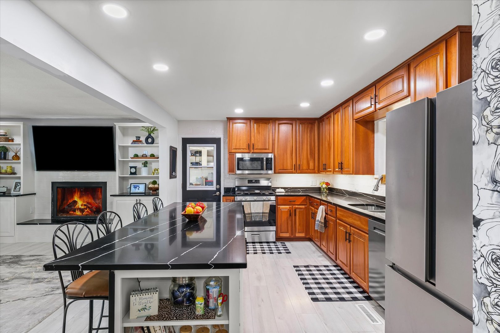 5 Golfview Drive Savoy, IL 61874 - Photo 12 of 42 a kitchen with stainless steel appliances granite countertop a refrigerator a stove top oven a sink dishwasher and dining table with wooden floor