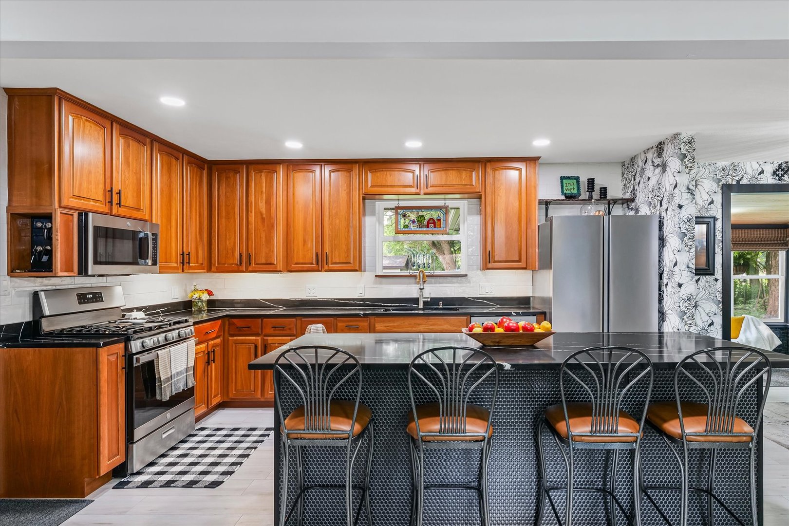 5 Golfview Drive Savoy, IL 61874 - Photo 14 of 42 a kitchen with stainless steel appliances granite countertop a stove top oven a sink dishwasher and cabinets with wooden floor