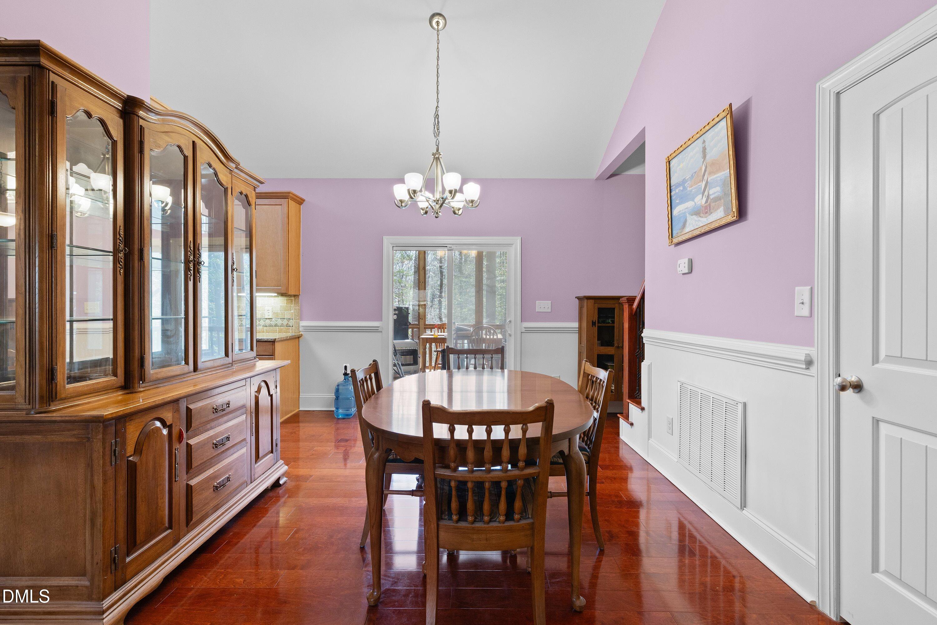 9713 Lake Wheeler Road Raleigh, NC 27603 - Photo 11 of 18 a view of a dining room with furniture and a chandelier