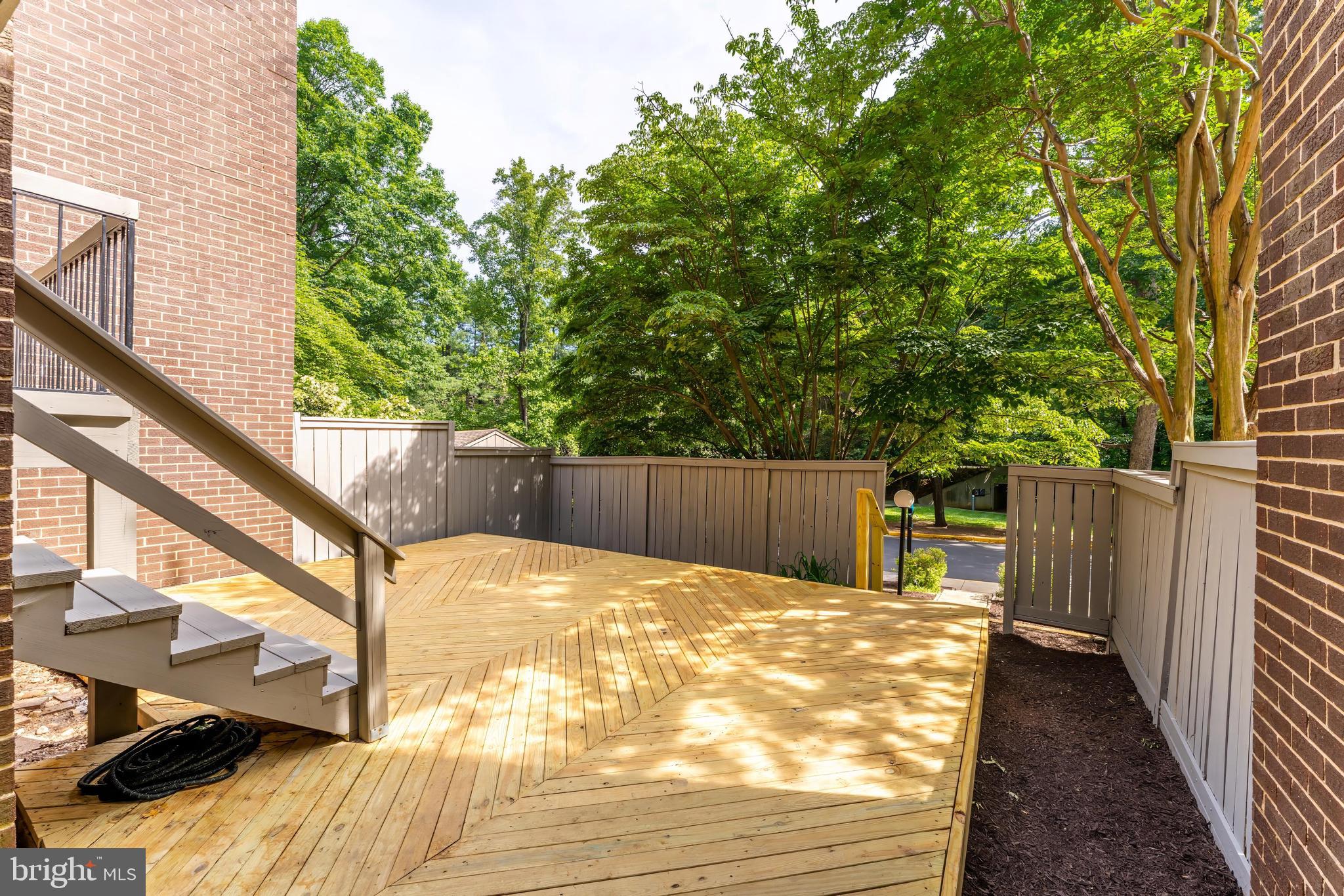12023 Insha Court Reston, VA 20191 - Photo 49 of 52 a view of backyard with wooden fence and trees