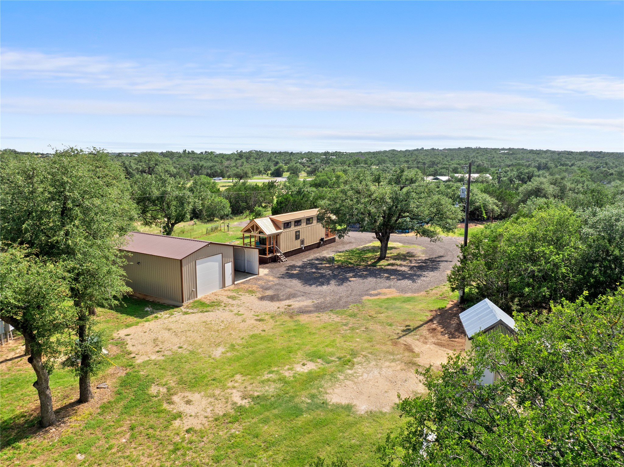 8200 Ranch Road 12 San Marcos, TX 78666 - Photo 4 of 40 A quaint residence with ample outdoor space, featuring a functional shed and verdant surroundings.