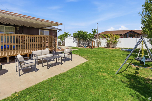 5108 South 2000th Street West Roy, UT 84067 - Photo 55 of 61 Fenced backyard featuring a patio area, outdoor lounge area, and a shed