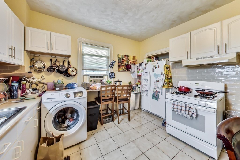 109 Walnut Street Somerville, MA 02145 - Photo 13 of 42 a view of a kitchen with fridge and wooden floor
