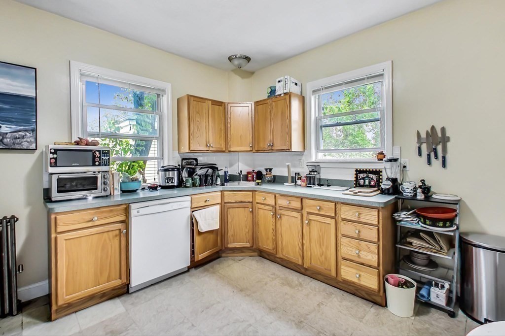 109 Walnut Street Somerville, MA 02145 - Photo 16 of 42 a kitchen with stainless steel appliances granite countertop a stove and a sink