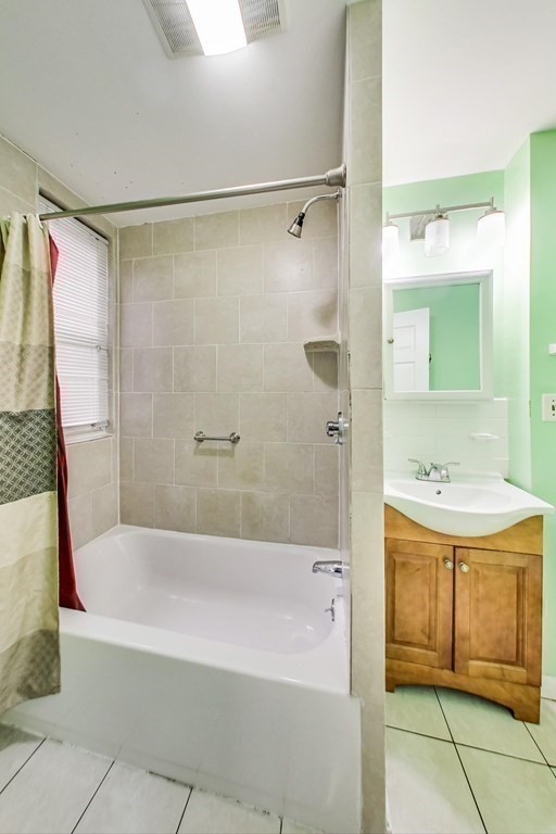 109 Walnut Street Somerville, MA 02145 - Photo 19 of 42 a bathroom with a sink a mirror and a bathtub