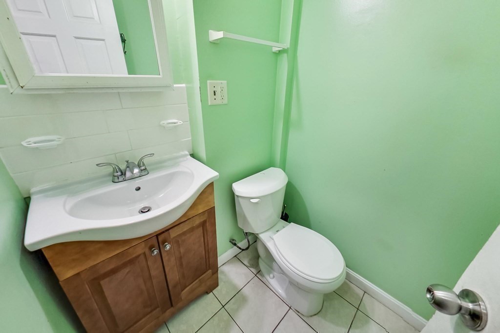 109 Walnut Street Somerville, MA 02145 - Photo 20 of 42 a bathroom with a sink a toilet and mirror