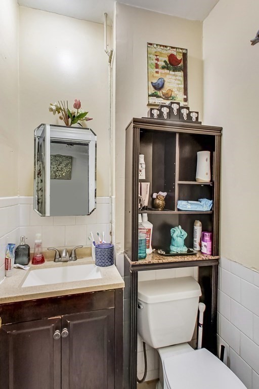 109 Walnut Street Somerville, MA 02145 - Photo 21 of 42 a bathroom with a toilet sink and mirror