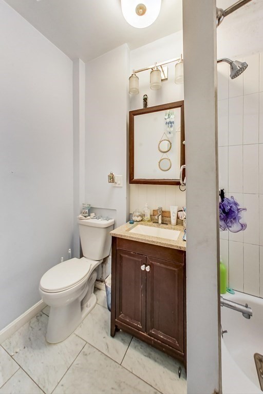 109 Walnut Street Somerville, MA 02145 - Photo 22 of 42 a bathroom with a granite countertop toilet and a sink