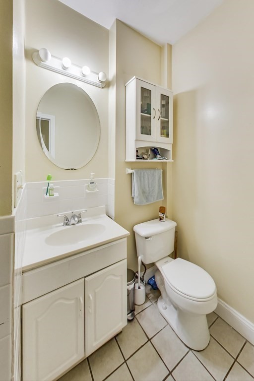 109 Walnut Street Somerville, MA 02145 - Photo 23 of 42 a bathroom with a toilet sink and mirror