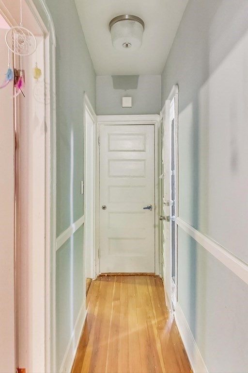 109 Walnut Street Somerville, MA 02145 - Photo 24 of 42 a view of a hallway with wooden floor and cabinet