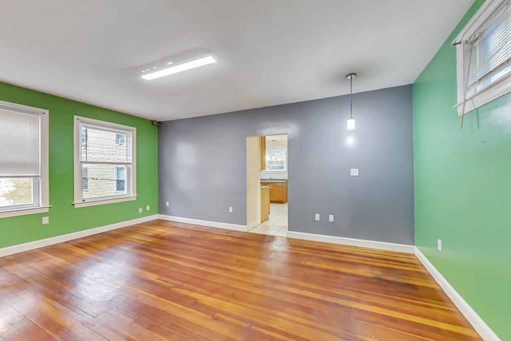 109 Walnut Street Somerville, MA 02145 - Photo 25 of 42 wooden floor in an empty room with a window