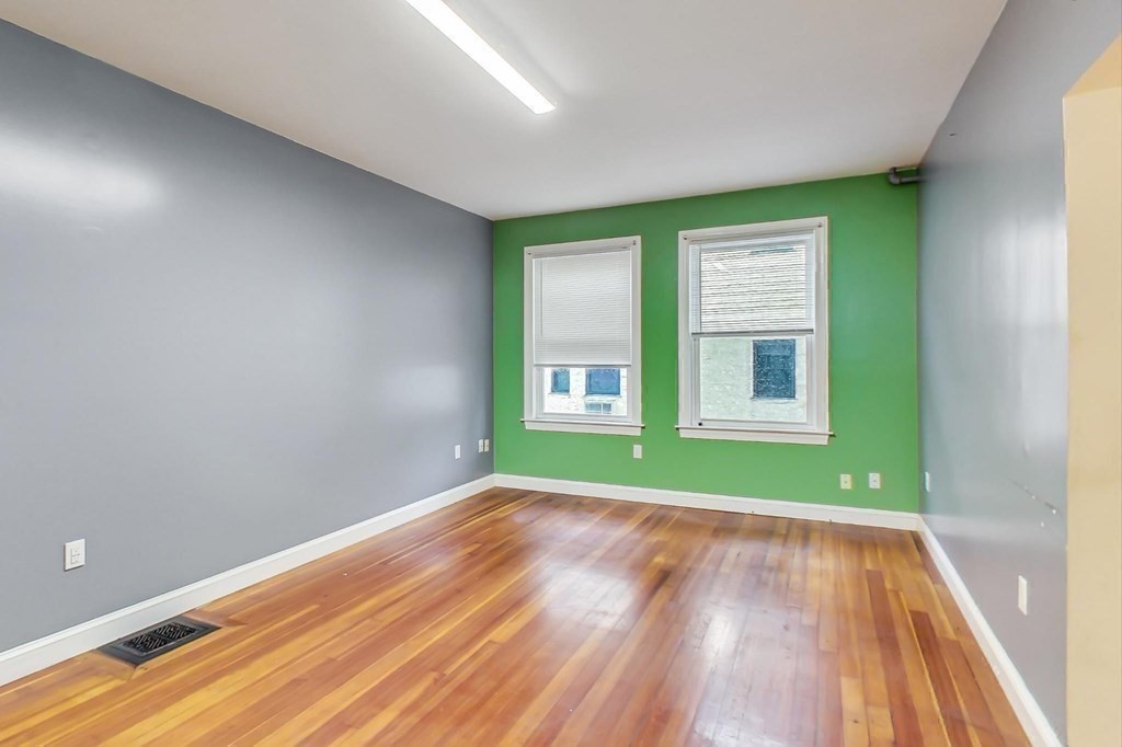 109 Walnut Street Somerville, MA 02145 - Photo 26 of 42 a view of an empty room with wooden floor and a window