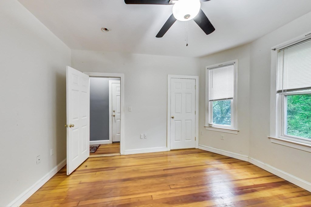 109 Walnut Street Somerville, MA 02145 - Photo 28 of 42 a view of an empty room with wooden floor and window