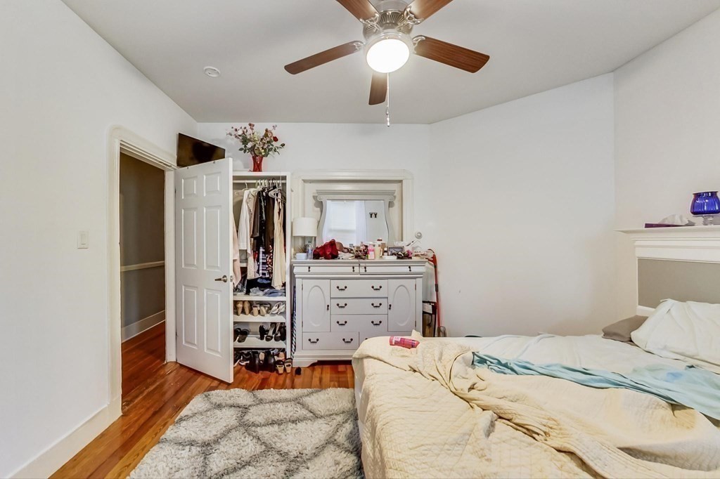 109 Walnut Street Somerville, MA 02145 - Photo 30 of 42 a bedroom with a bed and a chandelier