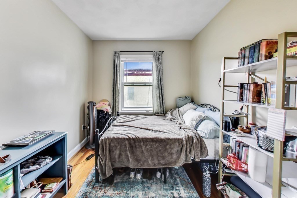 109 Walnut Street Somerville, MA 02145 - Photo 36 of 42 a bed sitting in a bedroom next to a window