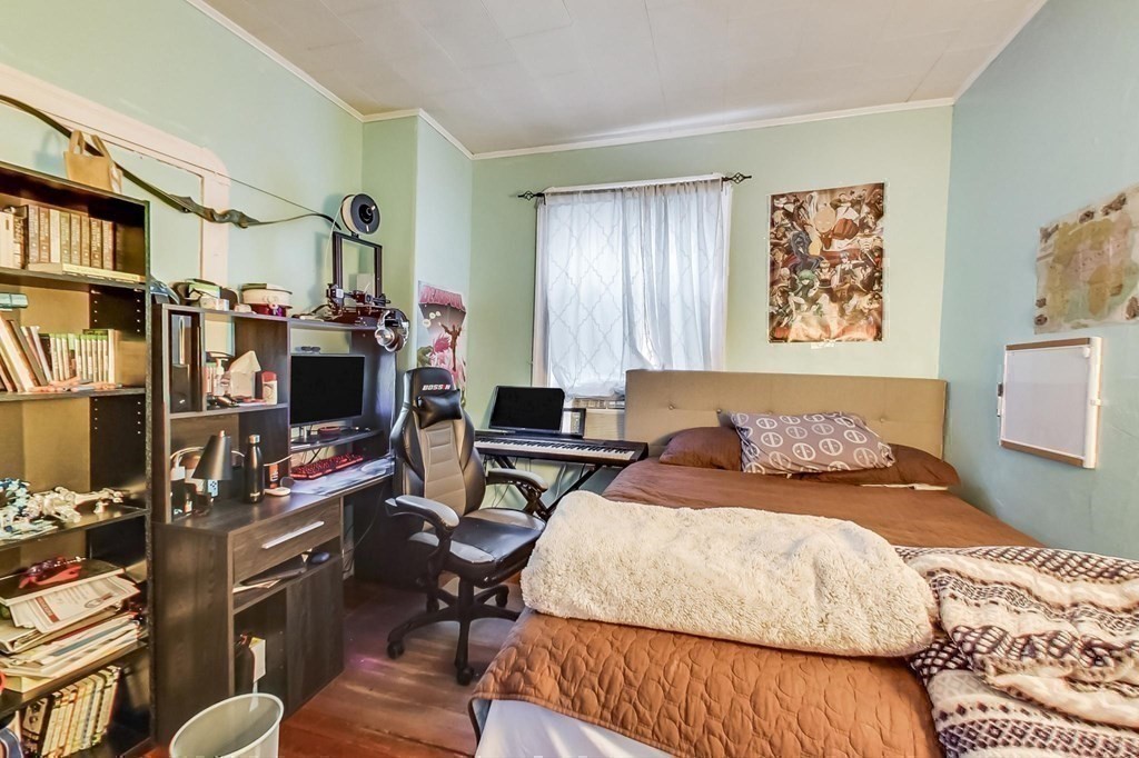 109 Walnut Street Somerville, MA 02145 - Photo 37 of 42 a bedroom with a bed computer on desk and a chair