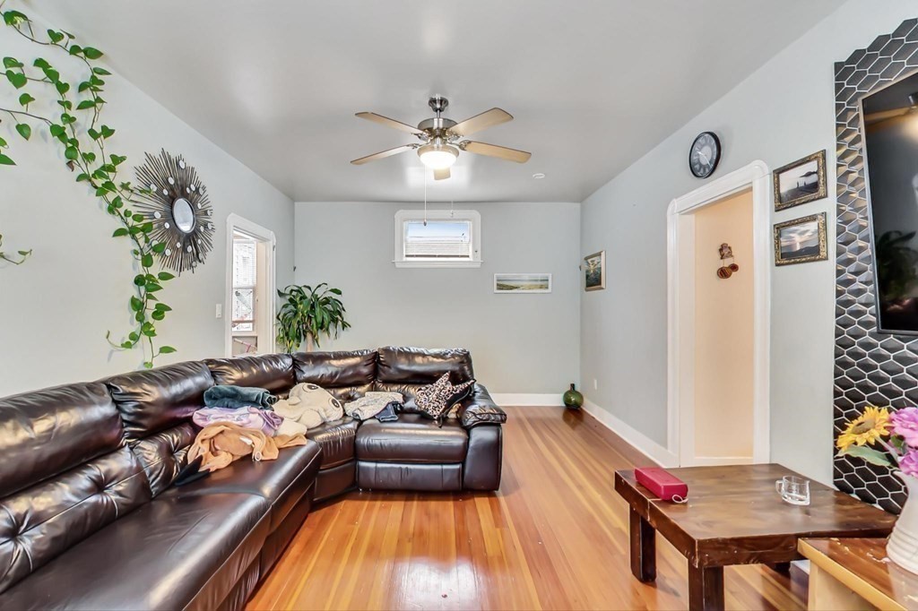 109 Walnut Street Somerville, MA 02145 - Photo 4 of 42 a living room with furniture and a chandelier