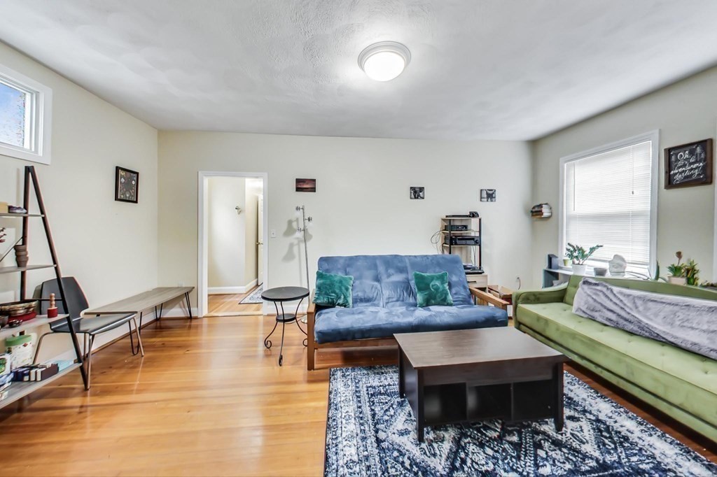 109 Walnut Street Somerville, MA 02145 - Photo 6 of 42 a living room with furniture and a wooden floor