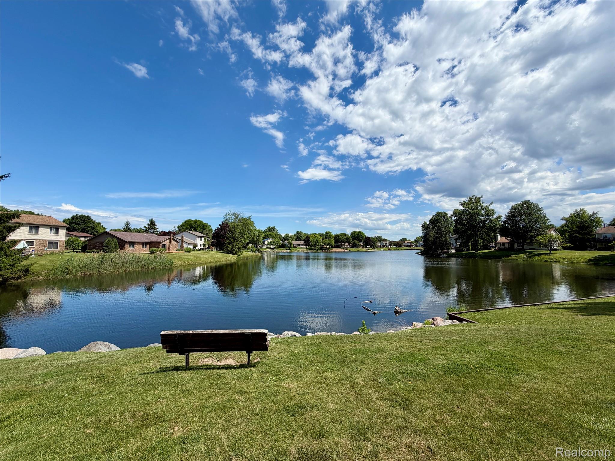 22533 Winfield Road Novi, MI 48375 - Photo 40 of 43 Expansive waterfront setting featuring a tranquil lake, manicured lawn, and mature trees