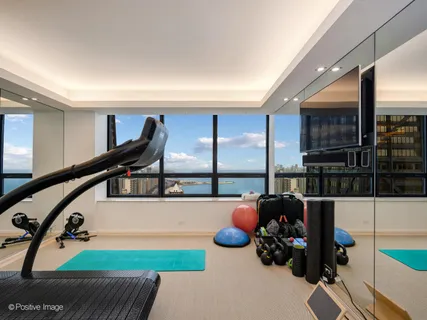 a spacious bedroom with a large bed and a large window