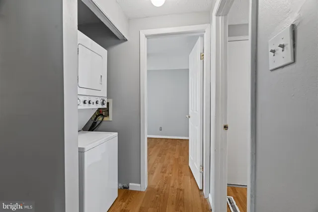 a view of a hallway with wooden floor and entryway