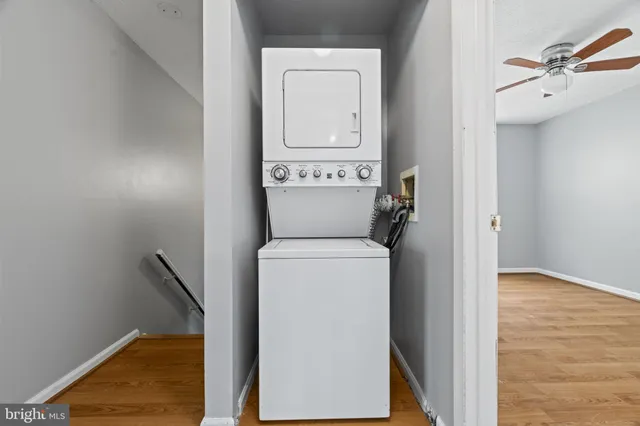 an empty room with a window and a ceiling fan