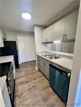 a kitchen with a sink a stove and cabinets