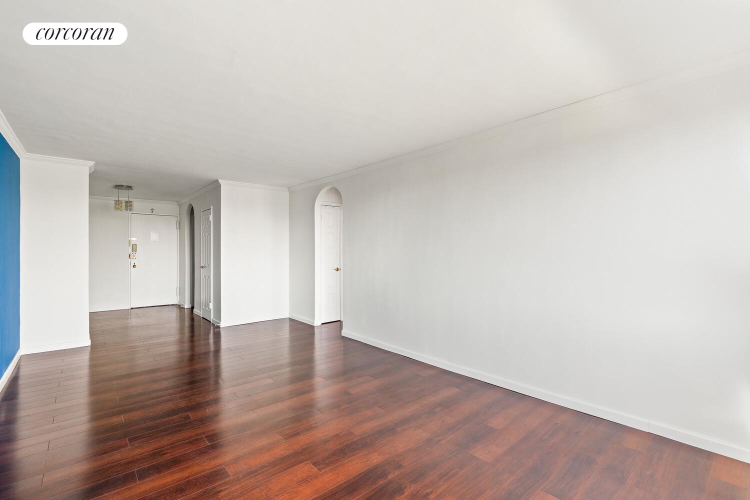 a view of an empty room and wooden floor