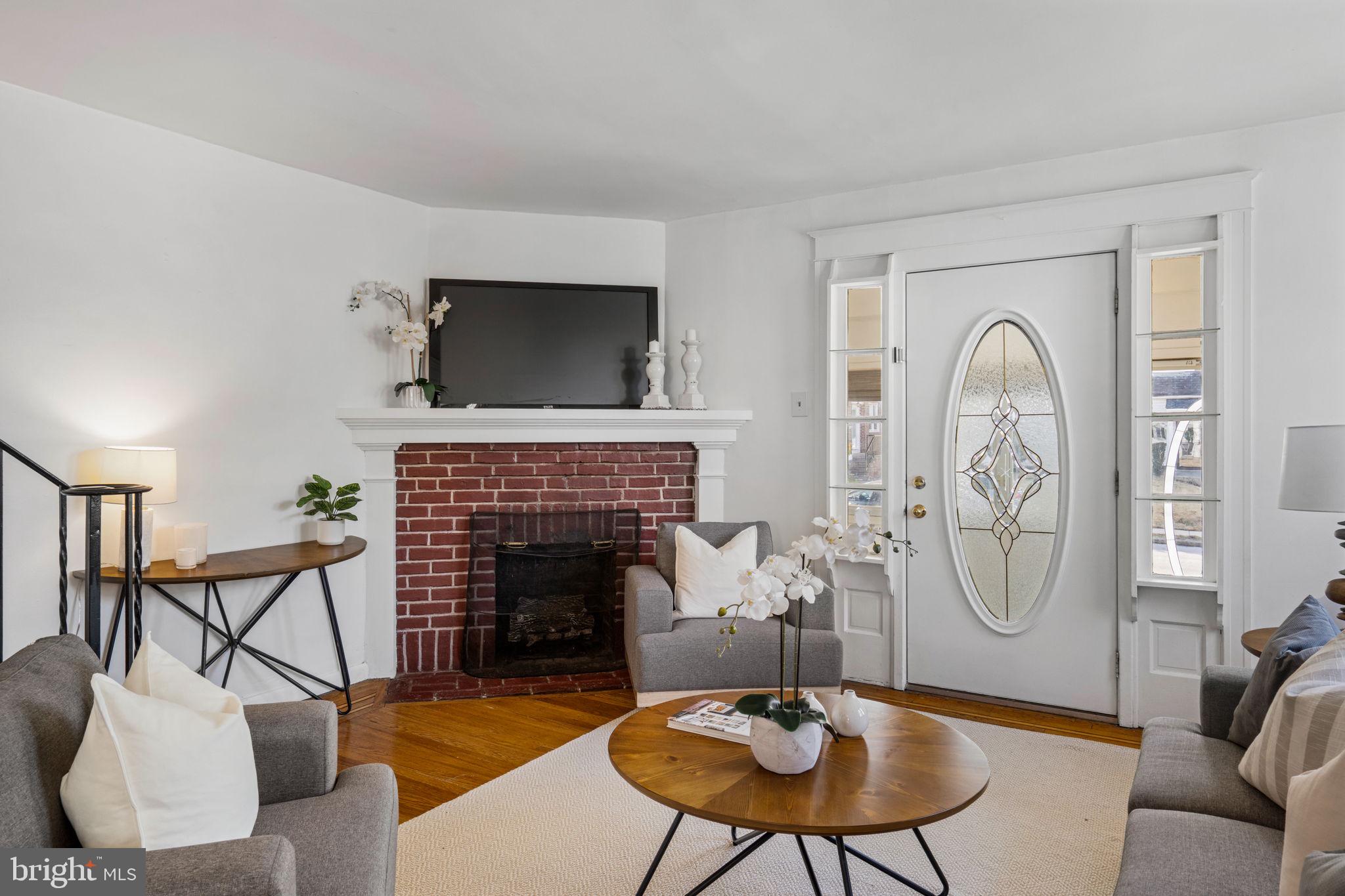 264 Pancoast Avenue Springfield, PA 19064 - Photo 11 of 38 a living room with furniture a flat screen tv and a fireplace