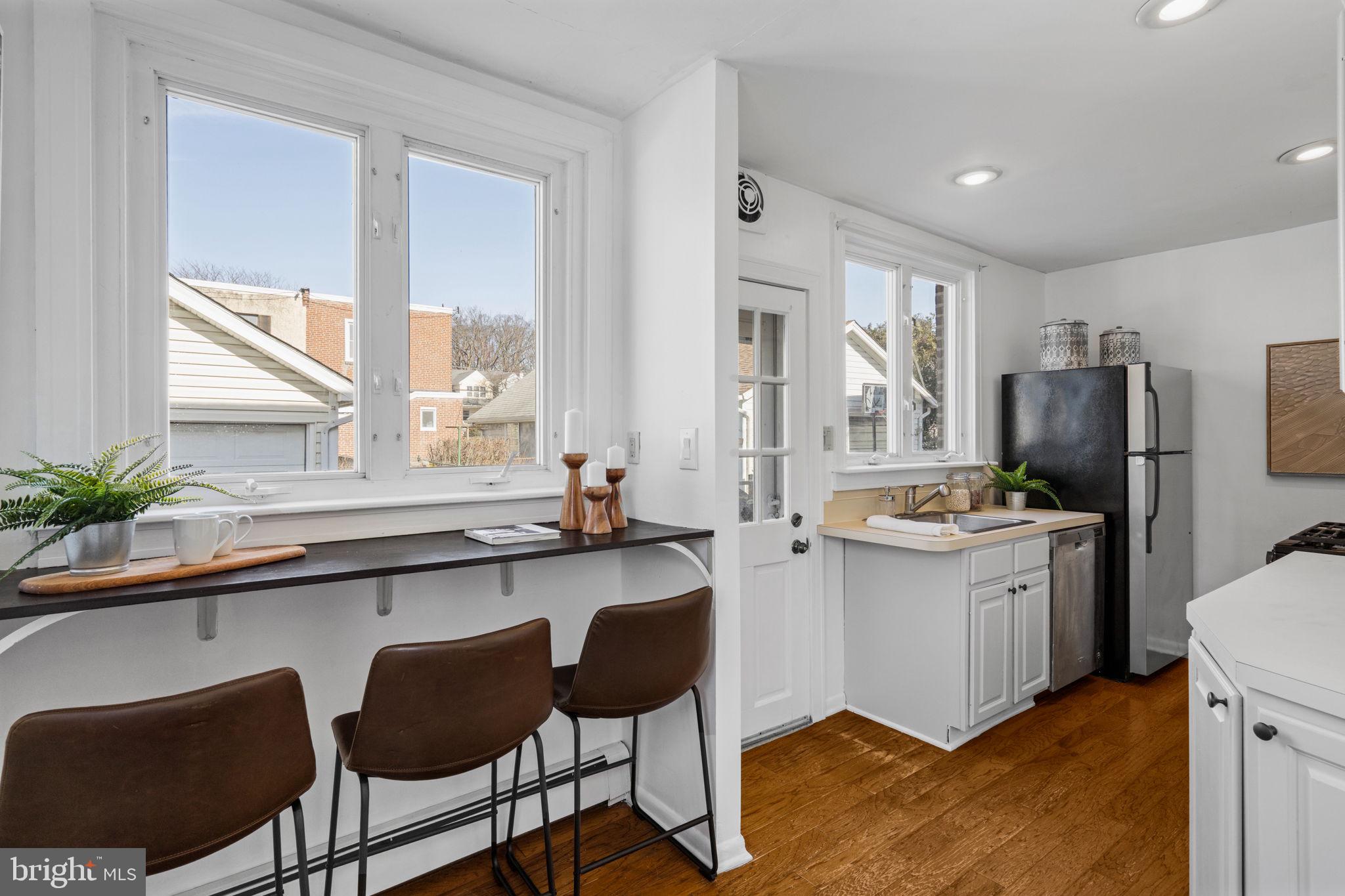 264 Pancoast Avenue Springfield, PA 19064 - Photo 17 of 38 a kitchen with a refrigerator a stove and white cabinets