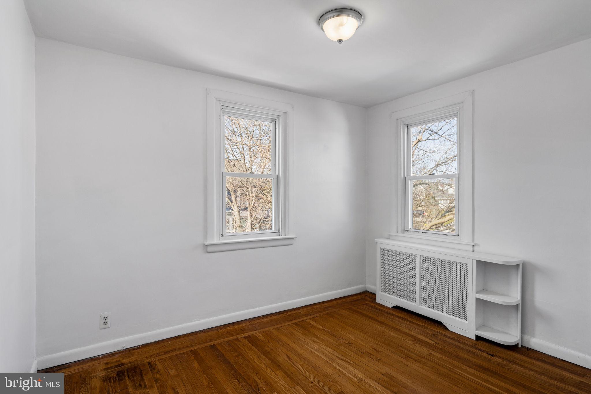 264 Pancoast Avenue Springfield, PA 19064 - Photo 26 of 38 an empty room with wooden floor and windows