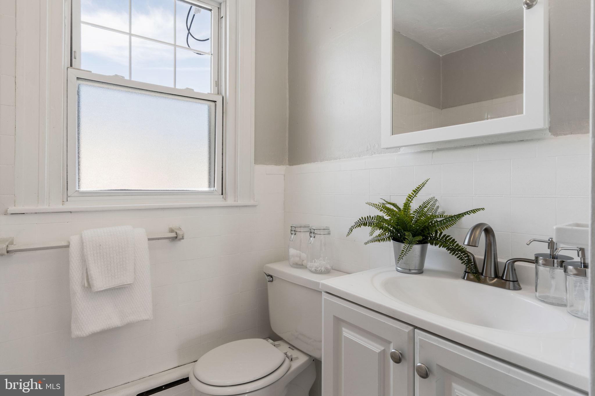 264 Pancoast Avenue Springfield, PA 19064 - Photo 28 of 38 a bathroom with a sink a toilet and mirror