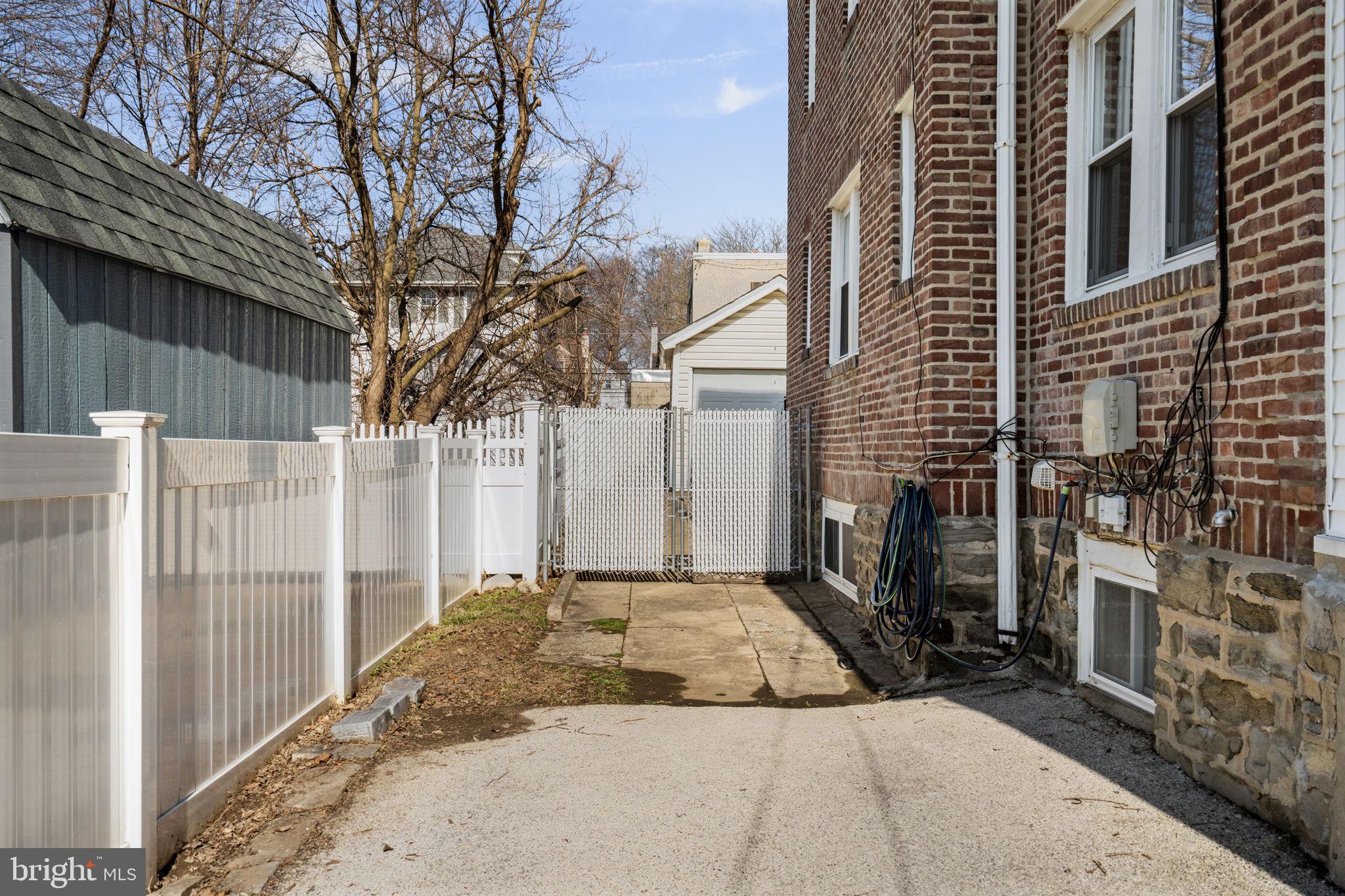 264 Pancoast Avenue Springfield, PA 19064 - Photo 34 of 38 a view of a house with a small yard and wooden fence