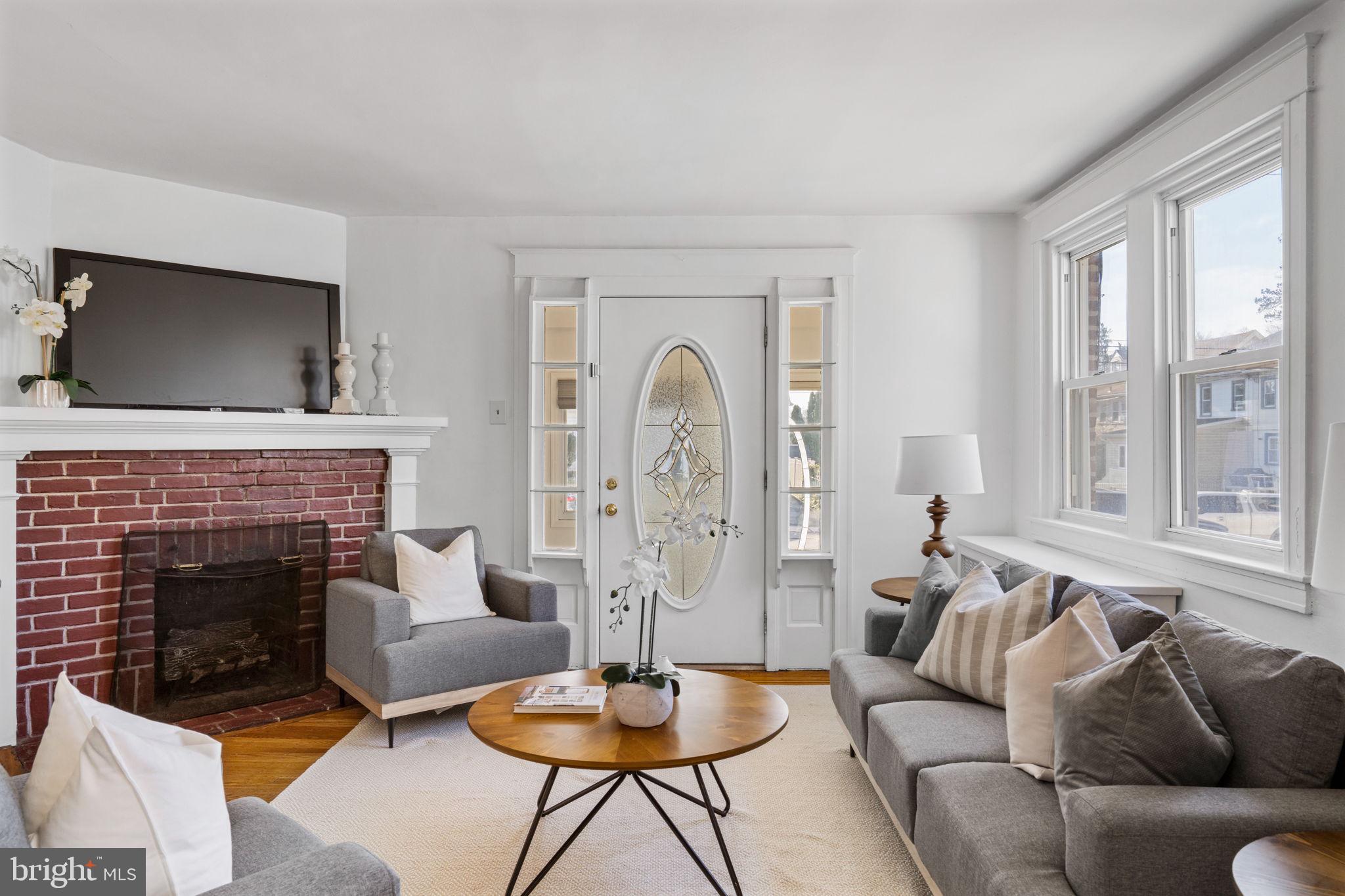264 Pancoast Avenue Springfield, PA 19064 - Photo 7 of 38 a living room with furniture a fireplace and a large window